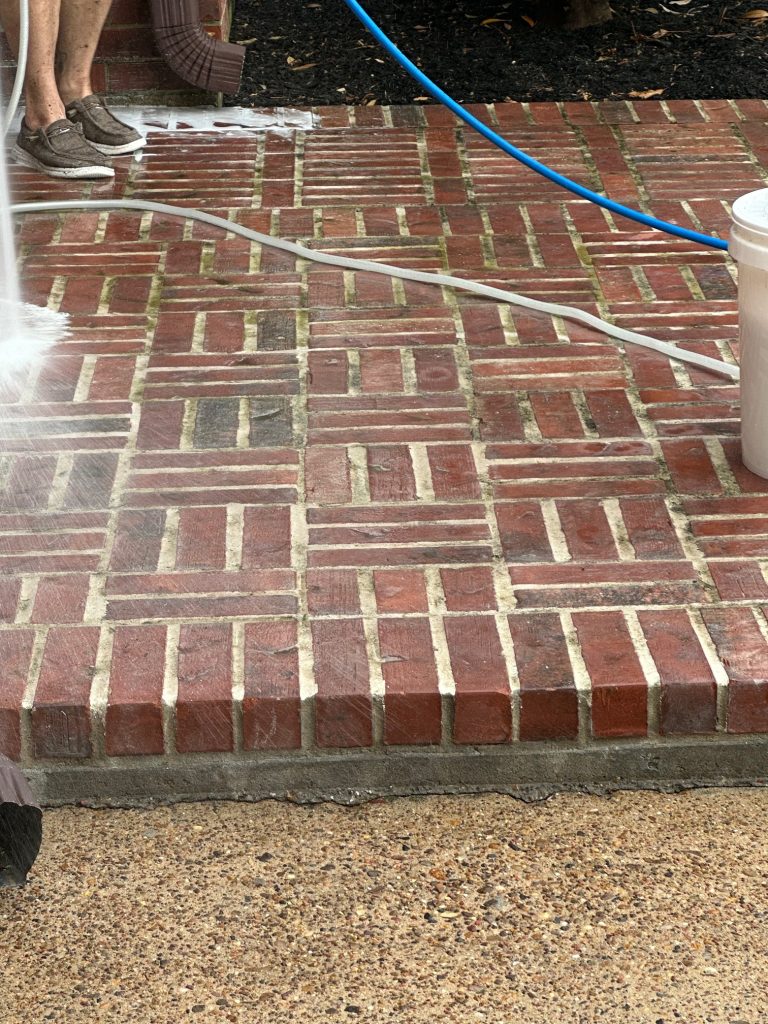 A patio being soaked with chemicals pressure washing Bacliff, TX